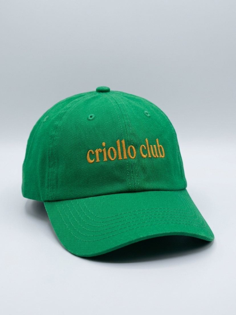 Green cap with 'criollo club' text on a light gray background